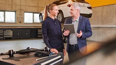 Two people speaking at garage.jpg